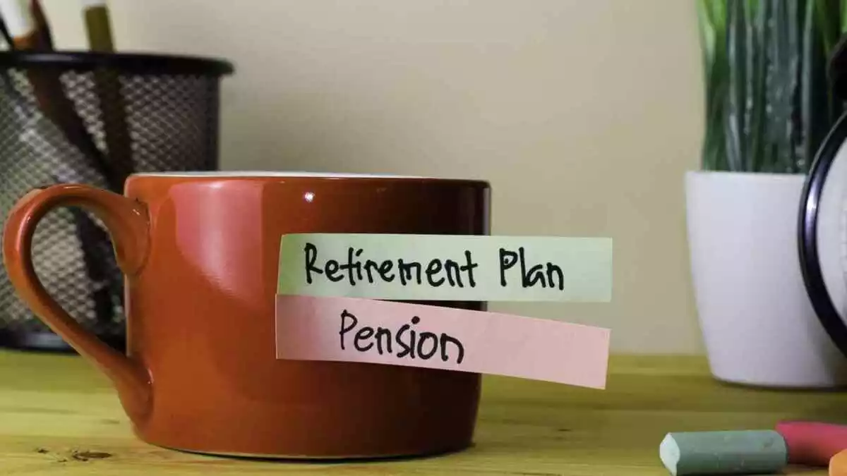 "Retirement plan" and "pension" written on a paper that's on a mug